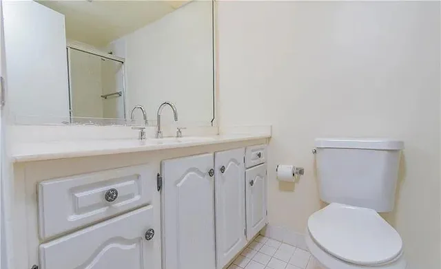 a white toilet sitting next to a bathroom sink