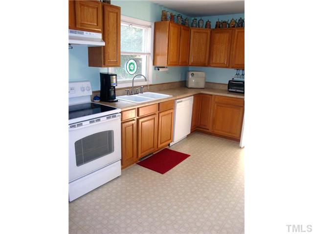 2318 Sheffield Road Raleigh, NC 27610 - Photo 3 of 15 a kitchen that has a sink and a stove in it