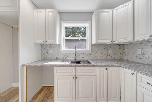 a kitchen with appliances cabinets and a window