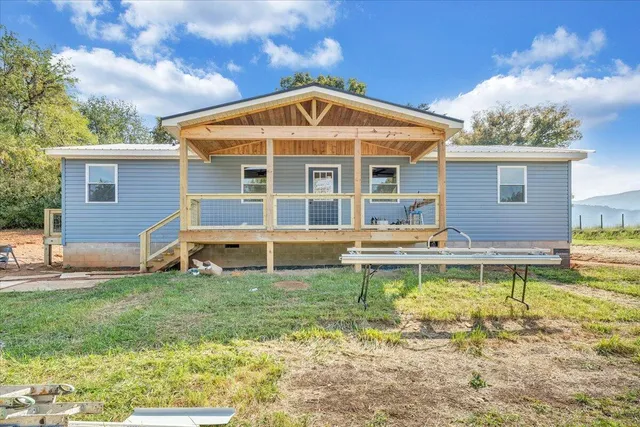 a view of a house with a yard patio and swimming pool