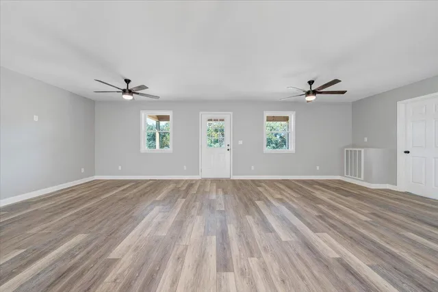 wooden floor in an empty room with a window