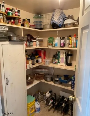 a view of a room with wooden floor and cabinet