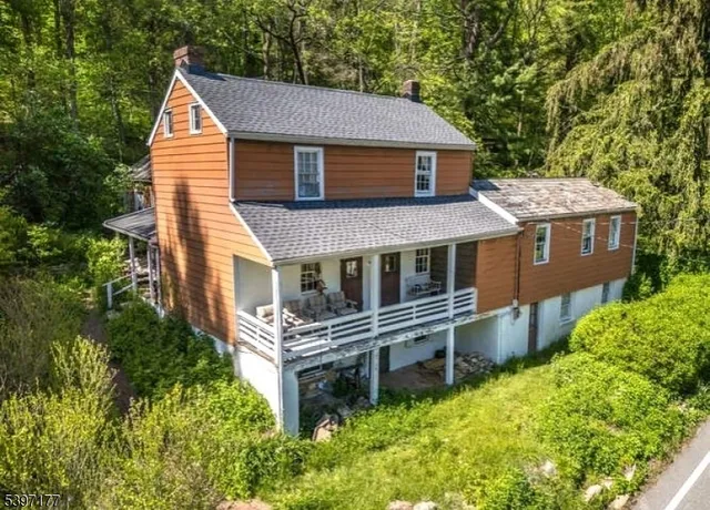 aerial view of a house with a yard and potted plants