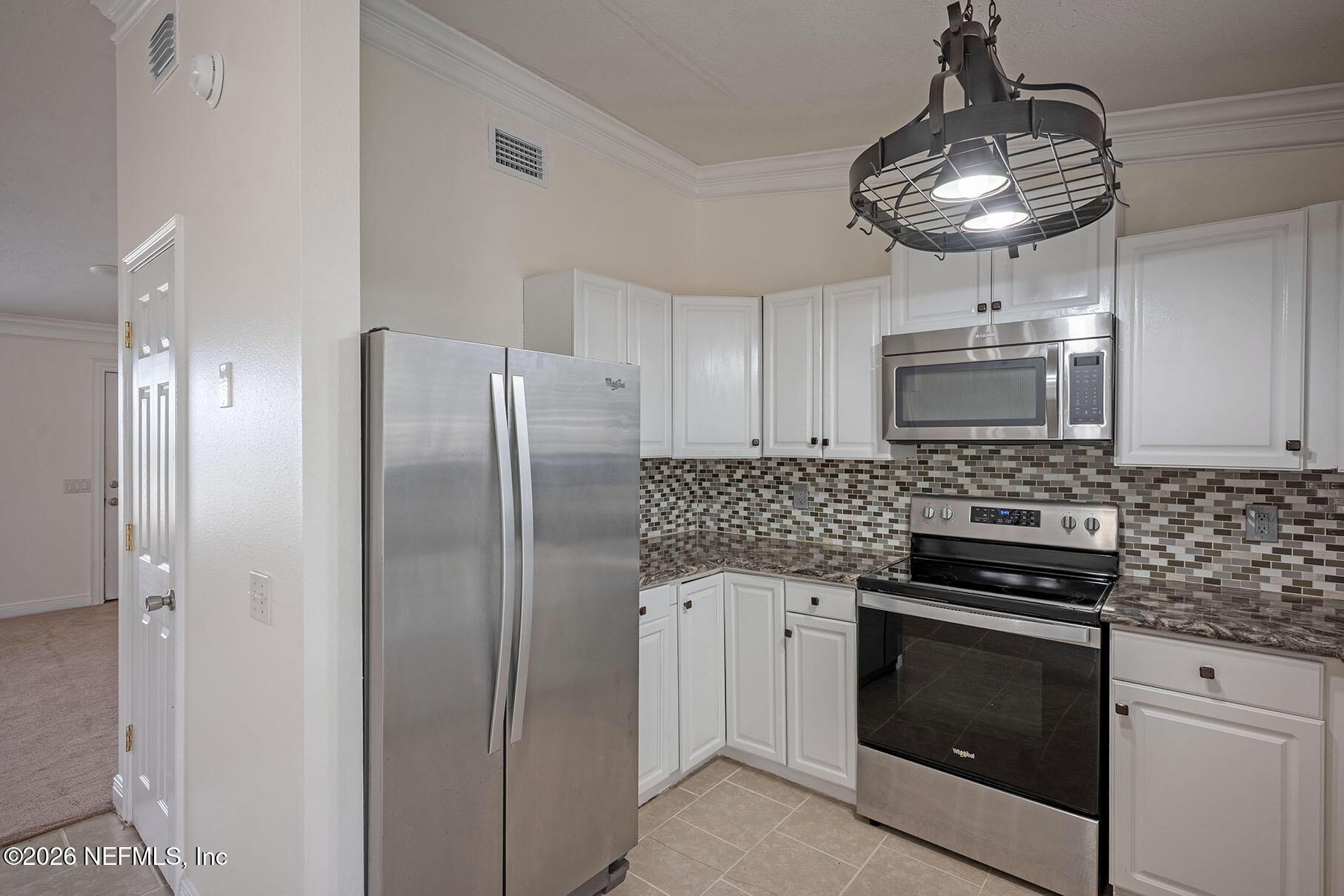 430 Southwest Jasmine Avenue Keystone Heights, FL 32656 - Photo 12 of 37 a kitchen with stainless steel appliances granite countertop a stove a refrigerator and a microwave