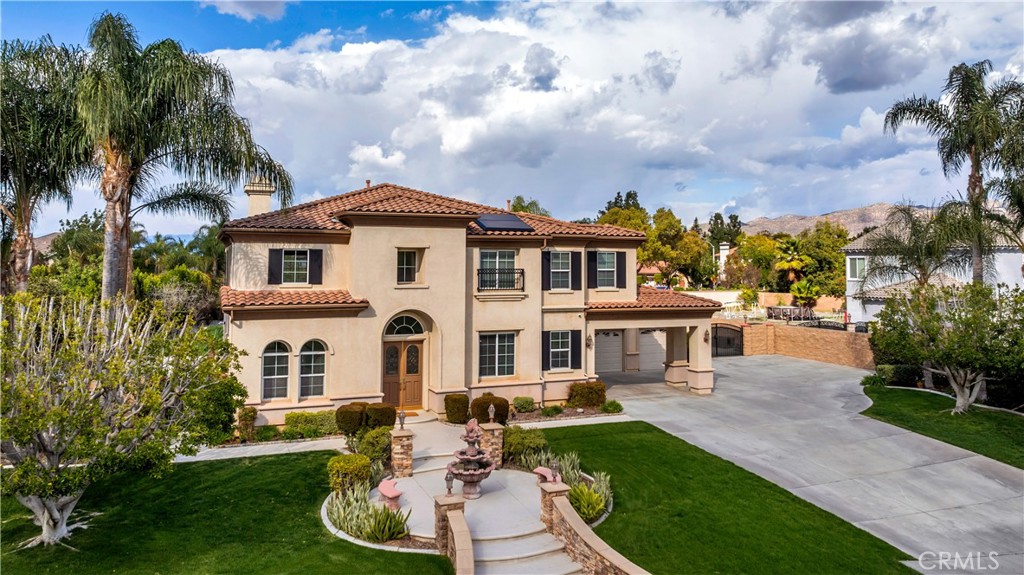 a front view of a house with a yard table and chairs