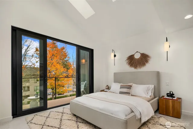 a bedroom with a large bed and a large window