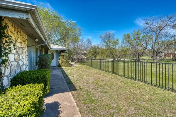 a view of a pathway of a house with a yard