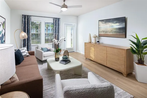 a living room with furniture and a potted plant