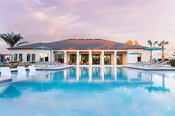 a front view of a house with swimming pool having outdoor seating