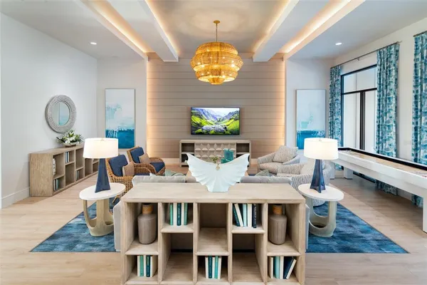 a dining room with wooden floor a chandelier a wooden table and chairs