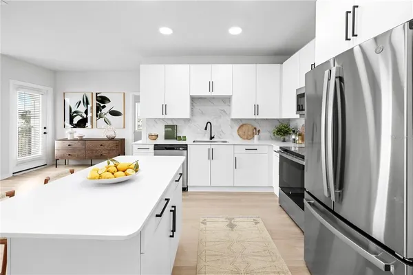 a kitchen with a sink refrigerator and window