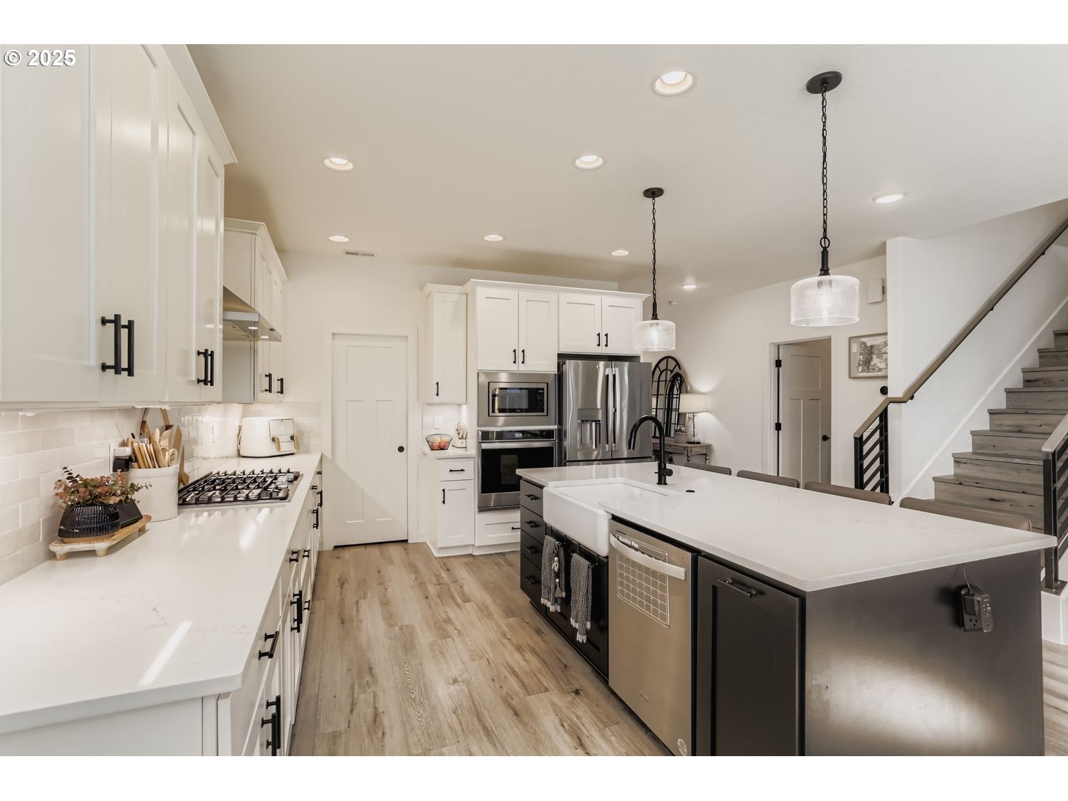 3651 Tiana Street Forest Grove, OR 97116 - Photo 12 of 27 a open kitchen with stainless steel appliances kitchen island a refrigerator sink and cabinets