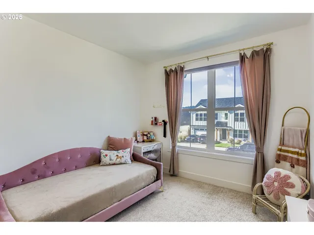 a bedroom with a bed and large window