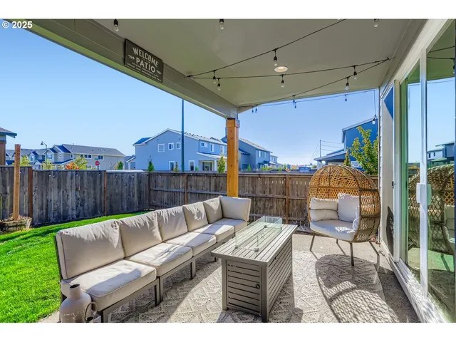 a view of a house with a backyard porch and sitting area