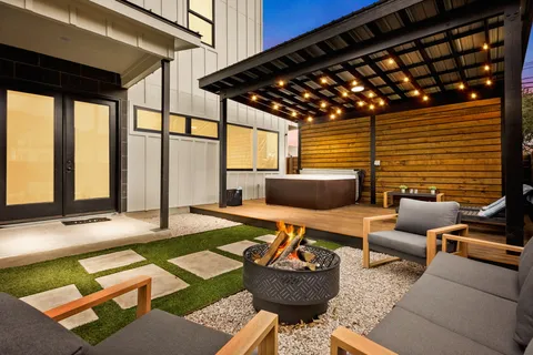 a outdoor space with patio couches and a dining table with garden view