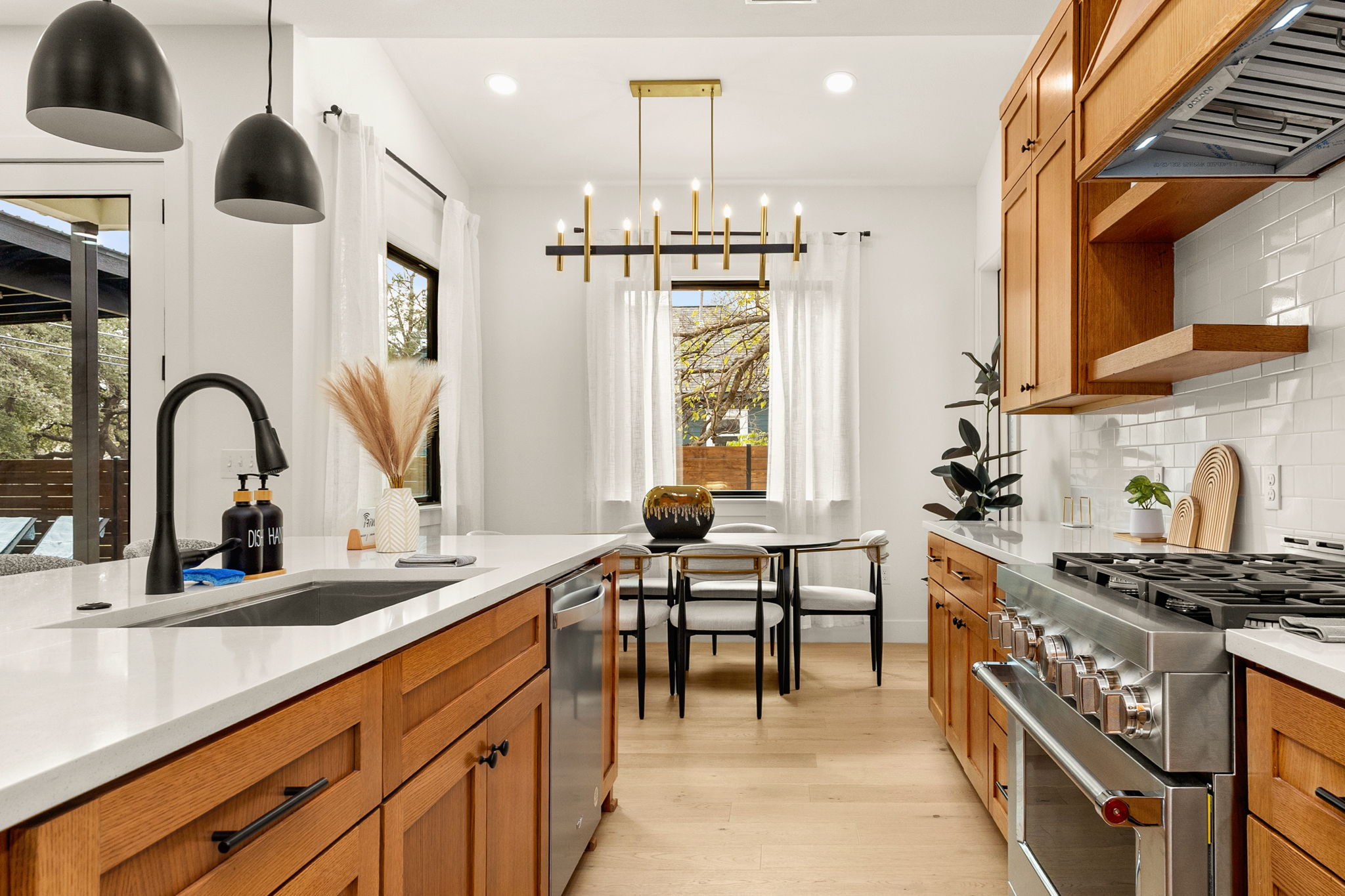 4418 Red River Street, Unit 1 Austin, TX 78751 - Photo 12 of 40 Kitchen featuring stainless steel appliances, open shelves, and wood finish cabinets