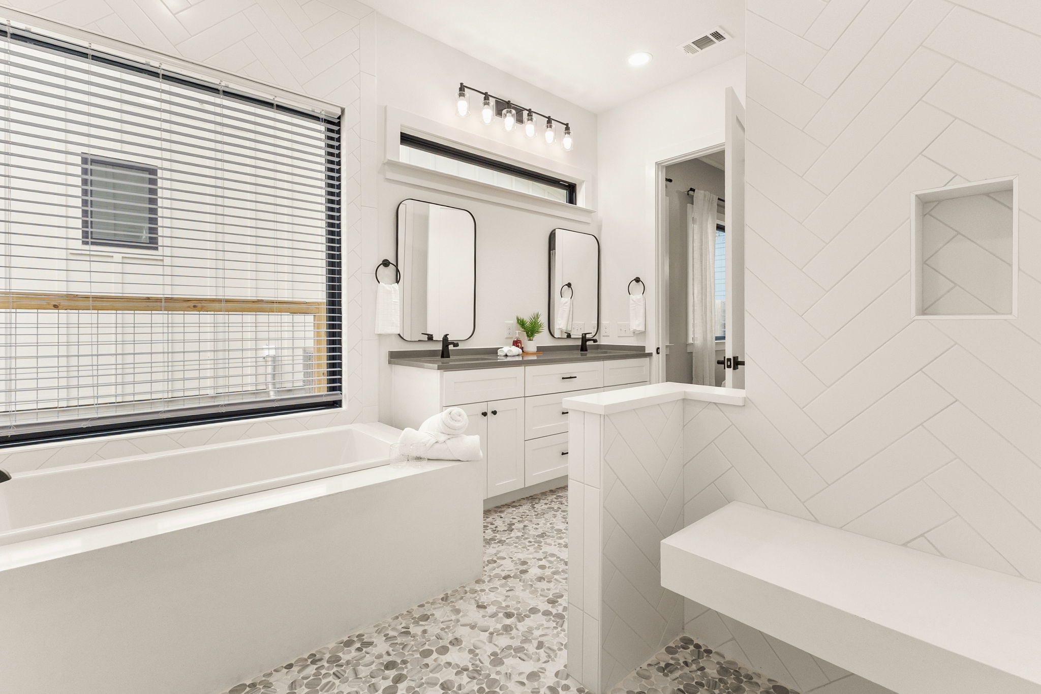4418 Red River Street, Unit 1 Austin, TX 78751 - Photo 18 of 40 Bathroom with double vanity, a bath, and tile walls