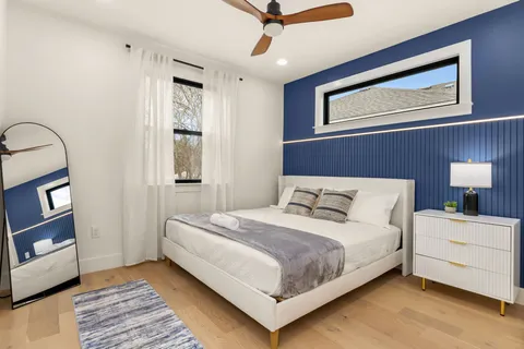 a bedroom with two beds and a large window