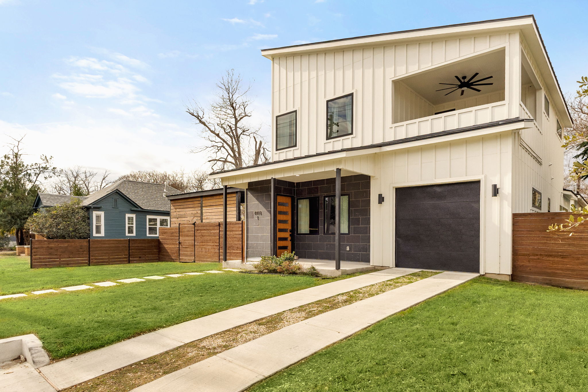 4418 Red River Street, Unit 1 Austin, TX 78751 - Photo 4 of 40 Modern farmhouse style home with board and batten siding, a garage, and porch