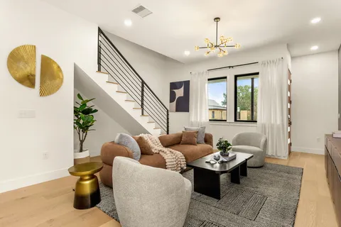 a living room with furniture and wooden floor