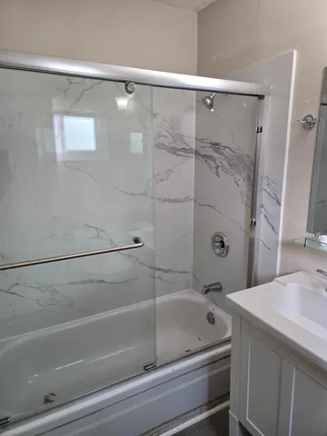a bathroom with a bathtub and a shower