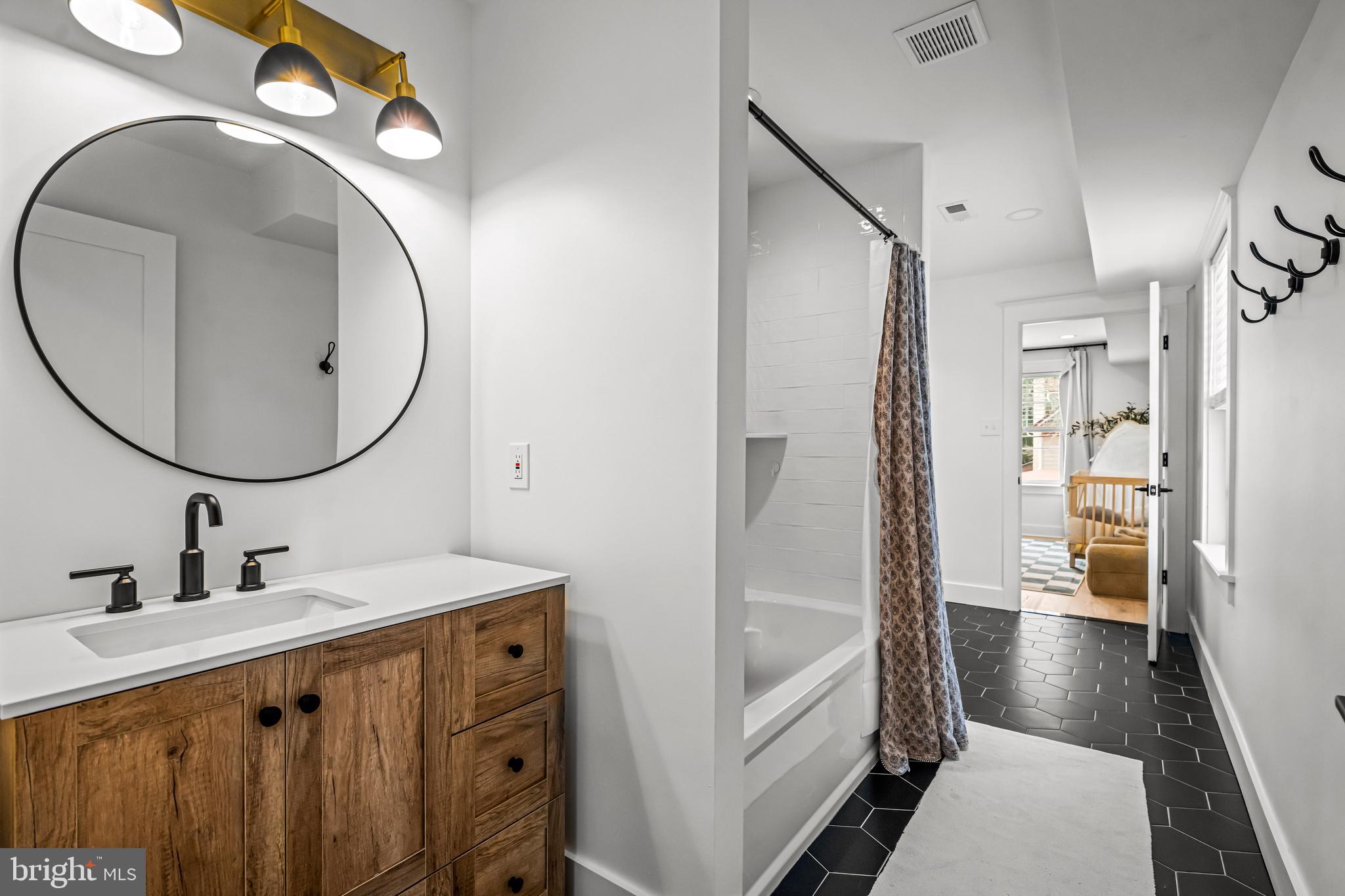 37 Estaugh Avenue Haddonfield, NJ 08033 - Photo 42 of 68 a bathroom with a sink a mirror and a shower