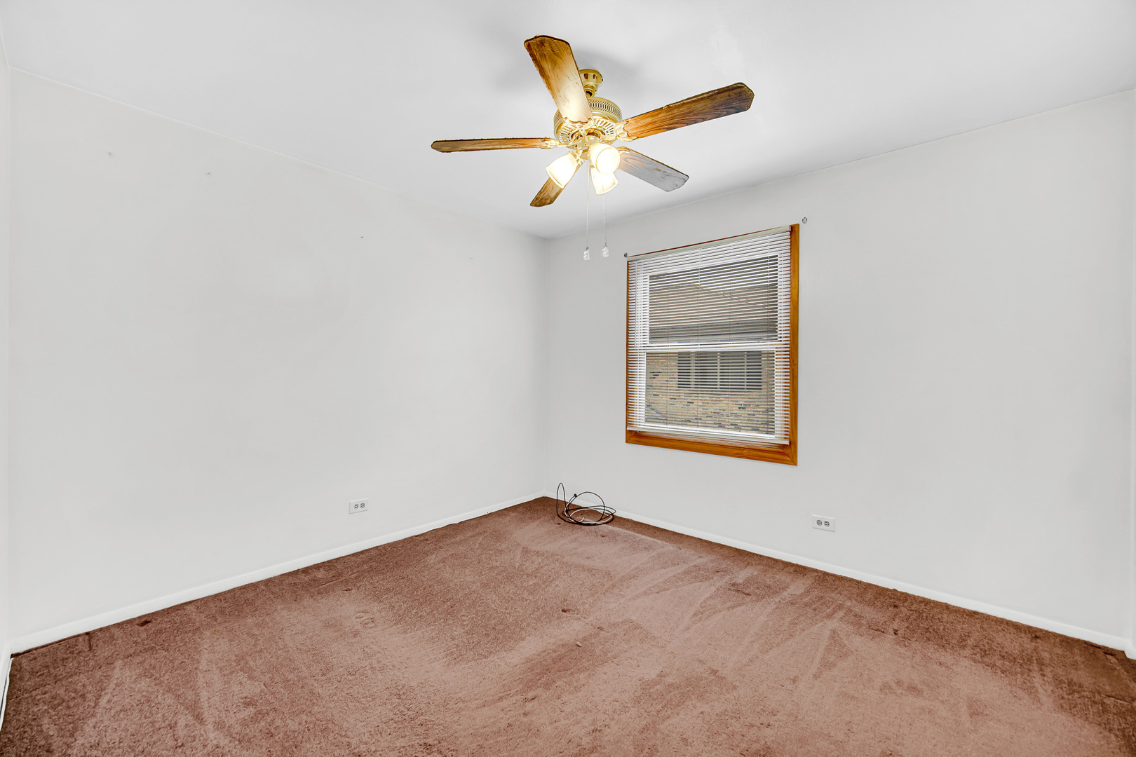1746 Sessions Walk, Unit 1746 Hoffman Estates, IL 60169 - Photo 16 of 19 an empty room with a window and a ceiling fan