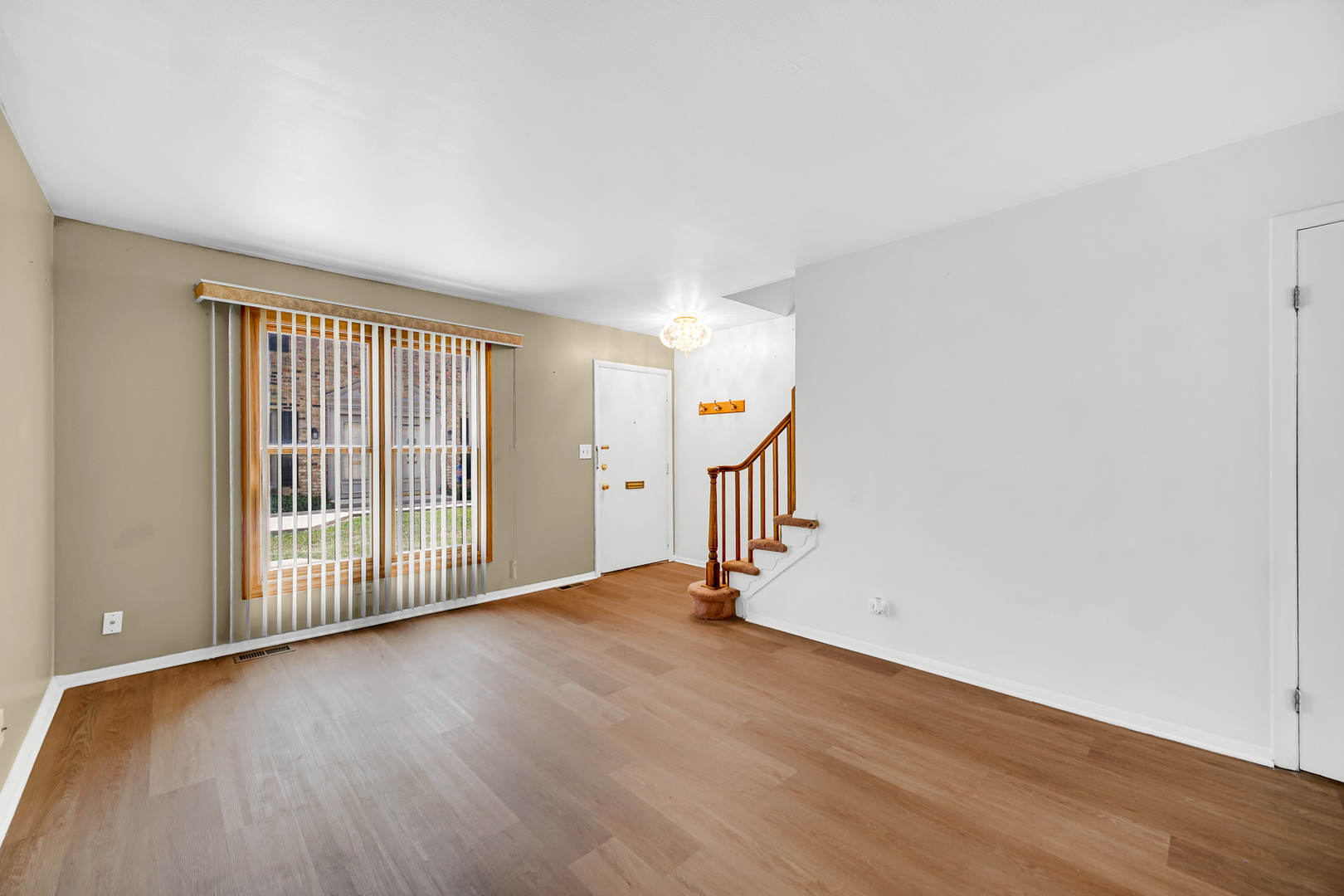 1746 Sessions Walk, Unit 1746 Hoffman Estates, IL 60169 - Photo 3 of 19 an empty room with wooden floor and windows