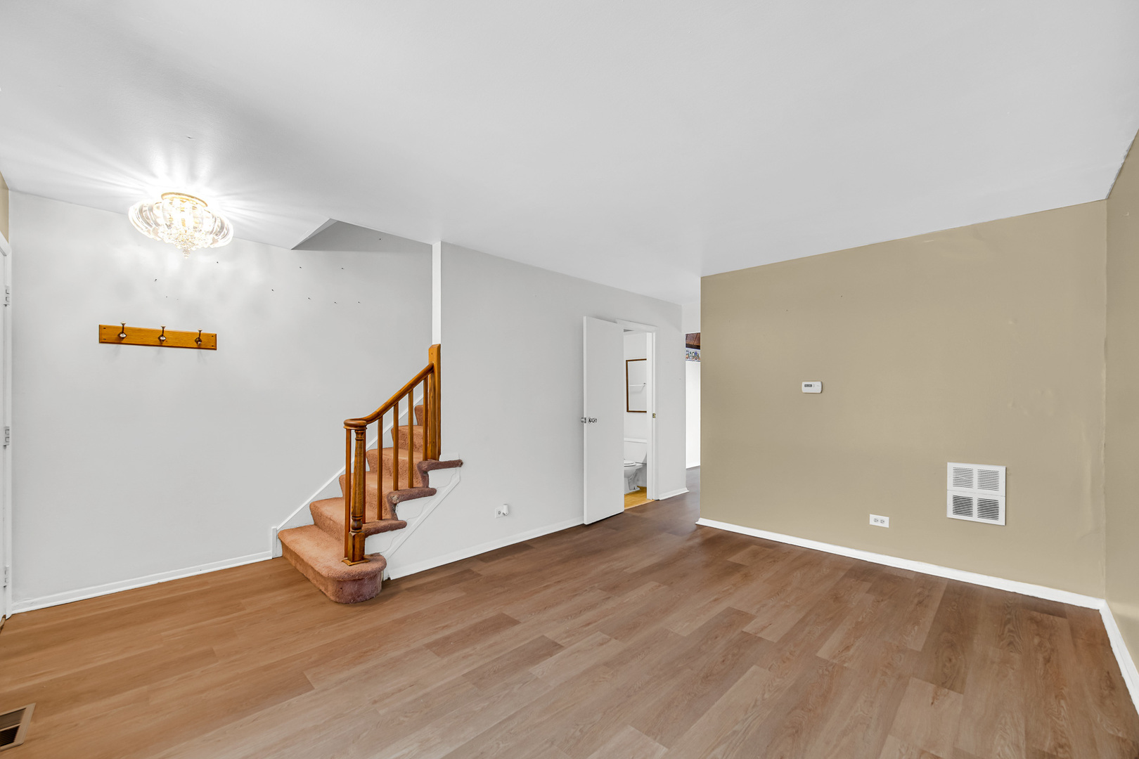 1746 Sessions Walk, Unit 1746 Hoffman Estates, IL 60169 - Photo 5 of 19 a view of an empty room with wooden floor