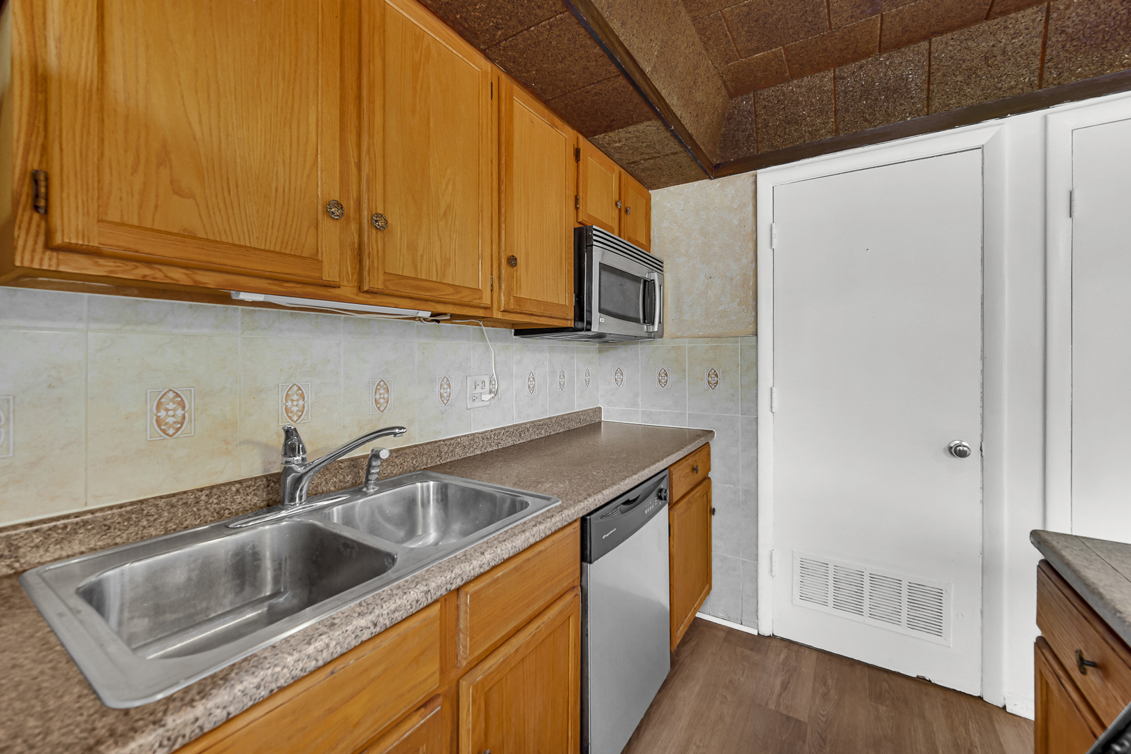 1746 Sessions Walk, Unit 1746 Hoffman Estates, IL 60169 - Photo 8 of 19 a kitchen with stainless steel appliances granite countertop a sink a stove and a microwave oven with cabinets