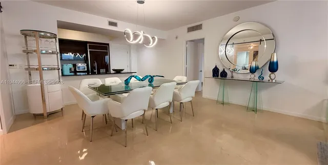 a view of a dining room with furniture and a chandelier