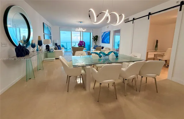 a living room with furniture a mirror and white walls