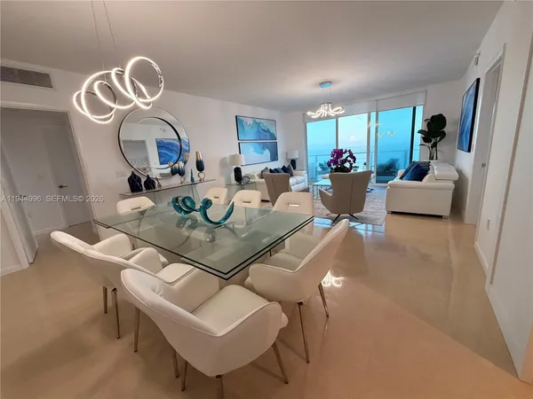 a dining room with furniture and a mirror