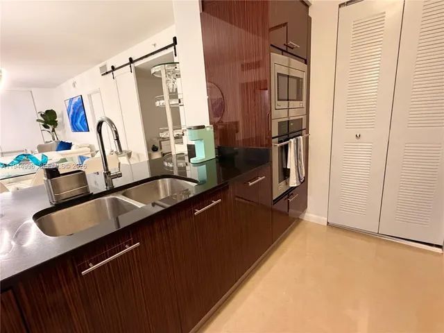 a kitchen with a sink and a refrigerator