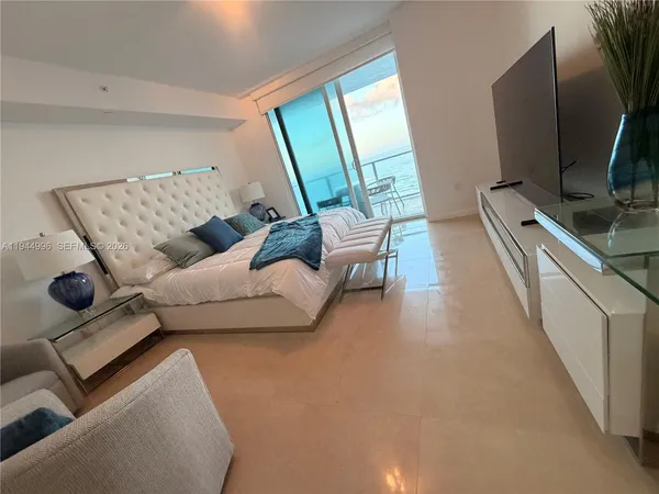 a bedroom with a bed and a couch