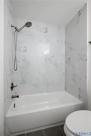 a bathroom with a bathtub and a toilet