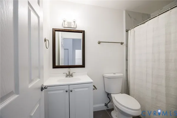 a bathroom with a toilet a sink and a mirror