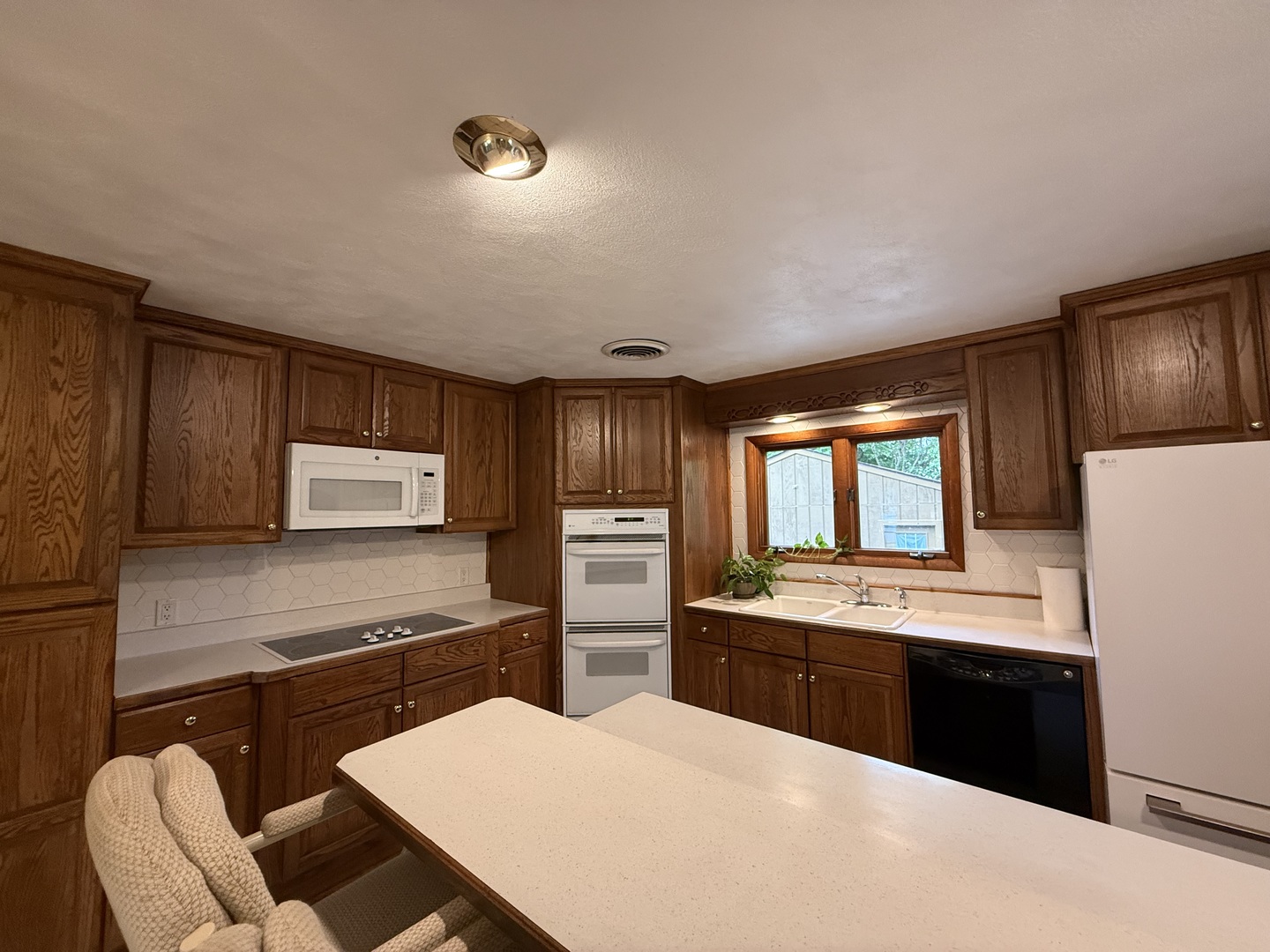1048 Warren Street Henry, IL 61537 - Photo 11 of 26 a kitchen with stainless steel appliances kitchen island granite countertop a sink stove and refrigerator