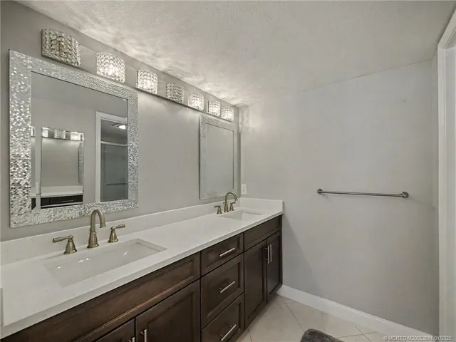 a bathroom with a double vanity sink and a mirror