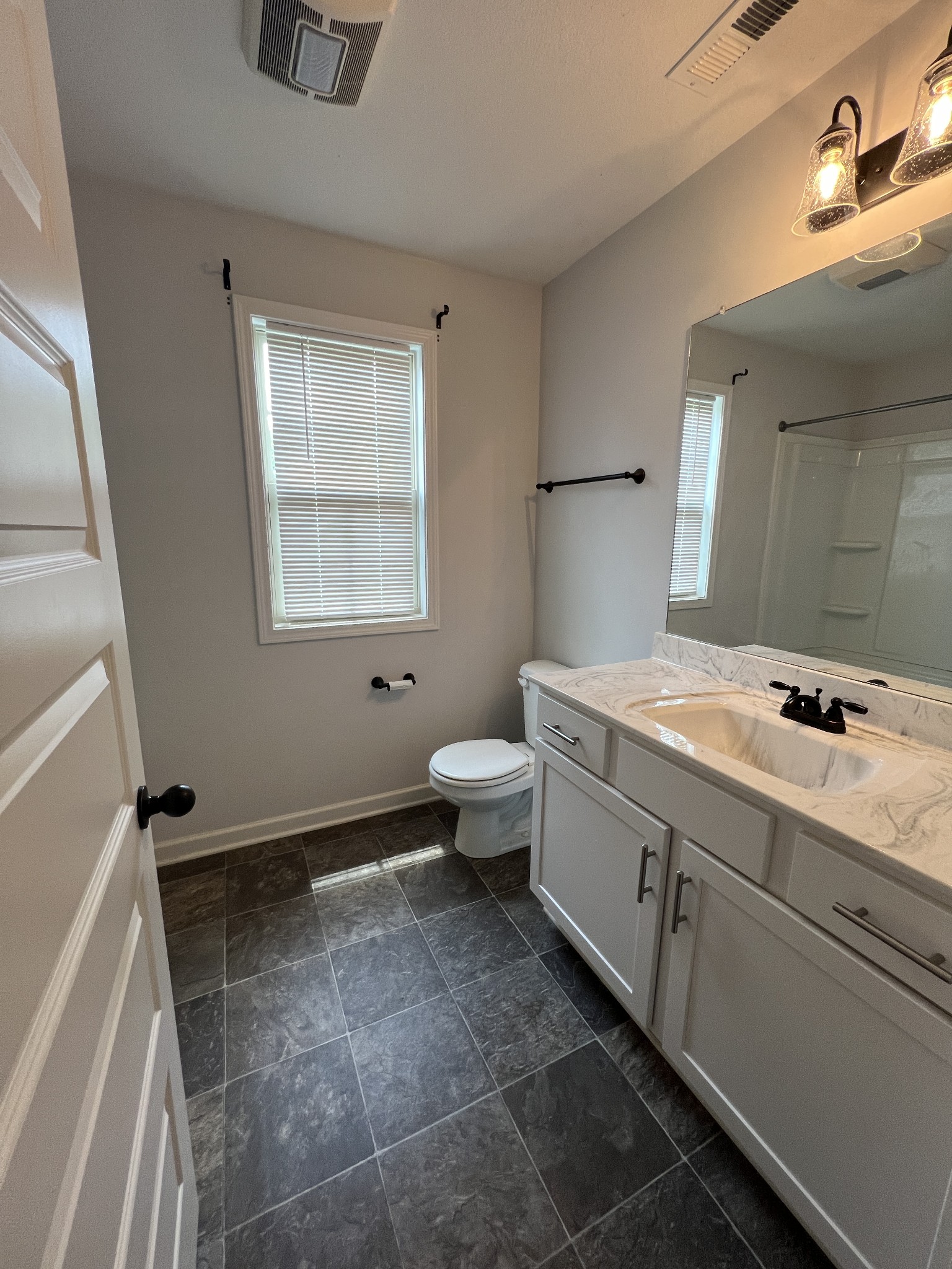 660 Elm Street Clarksville, TN 37040 - Photo 16 of 34 a bathroom with a double vanity sink toilet and a mirror