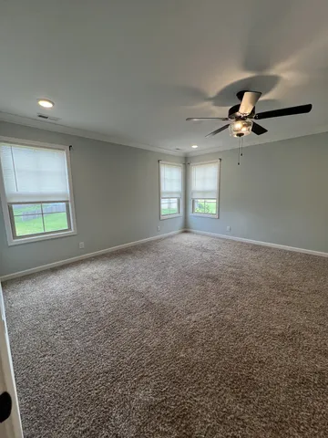 a view of a livingroom with a ceiling fan and window