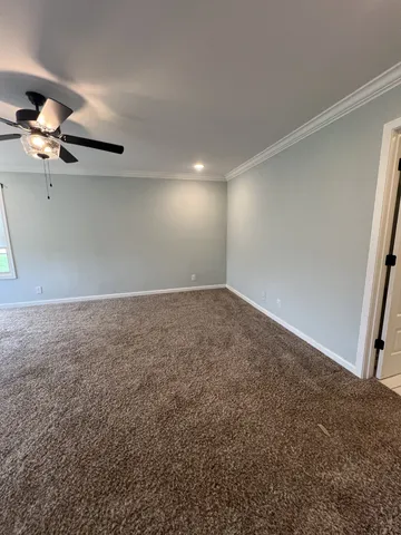 a view of an empty room and a window