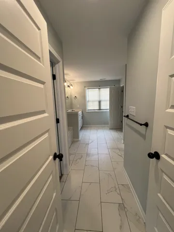 a spacious bathroom with a double vanity sink and a mirror