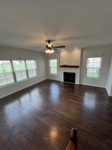 a view of a living room a window and wooden floor