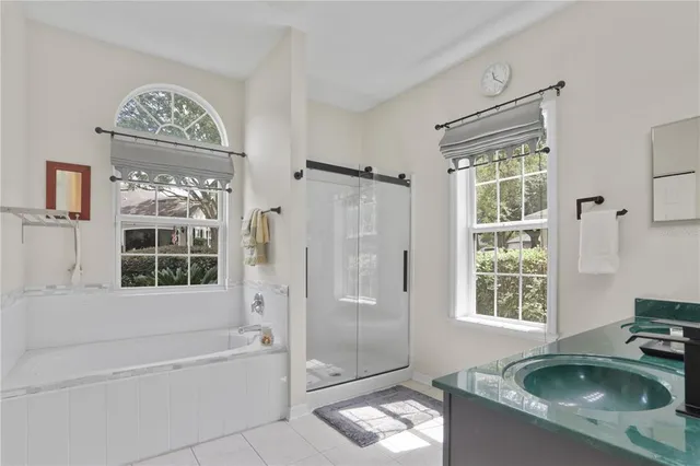 a bathroom with a sink a bathtub and a shower