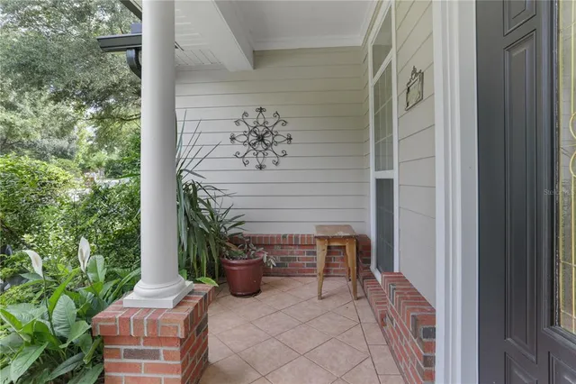 a view of backyard with outdoor seating and plants