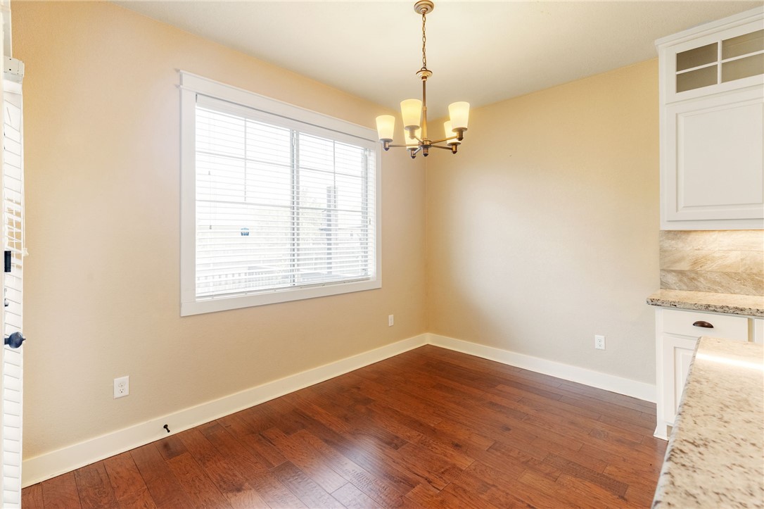 2136 Rockcliffe Loop College Station, TX 77845 - Photo 23 of 48 a view of empty room with wooden floor window and chandelier