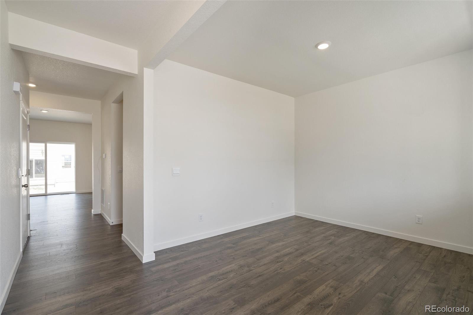 219 Haymaker Lane Severance, CO 80550 - Photo 15 of 44 a view of a hallway with wooden floor