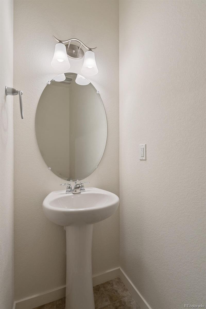 219 Haymaker Lane Severance, CO 80550 - Photo 17 of 44 a bathroom with a sink and mirror