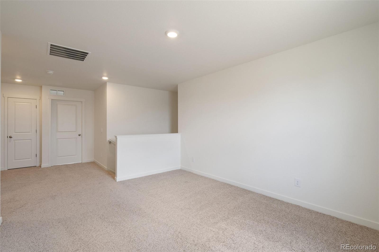 219 Haymaker Lane Severance, CO 80550 - Photo 18 of 44 an empty room with white wall and kitchen space